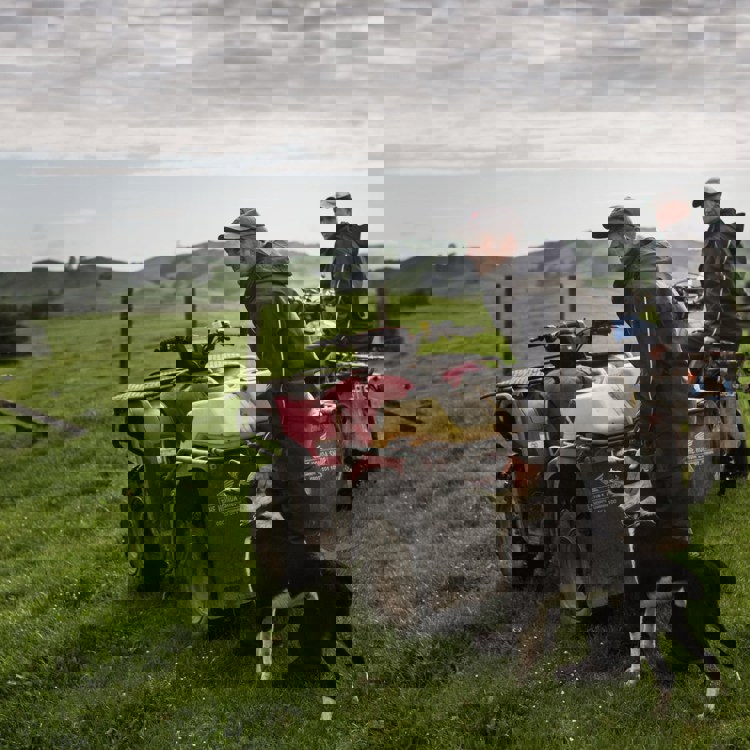 two men in field with dog and quad wearing kaiwaka farm wear